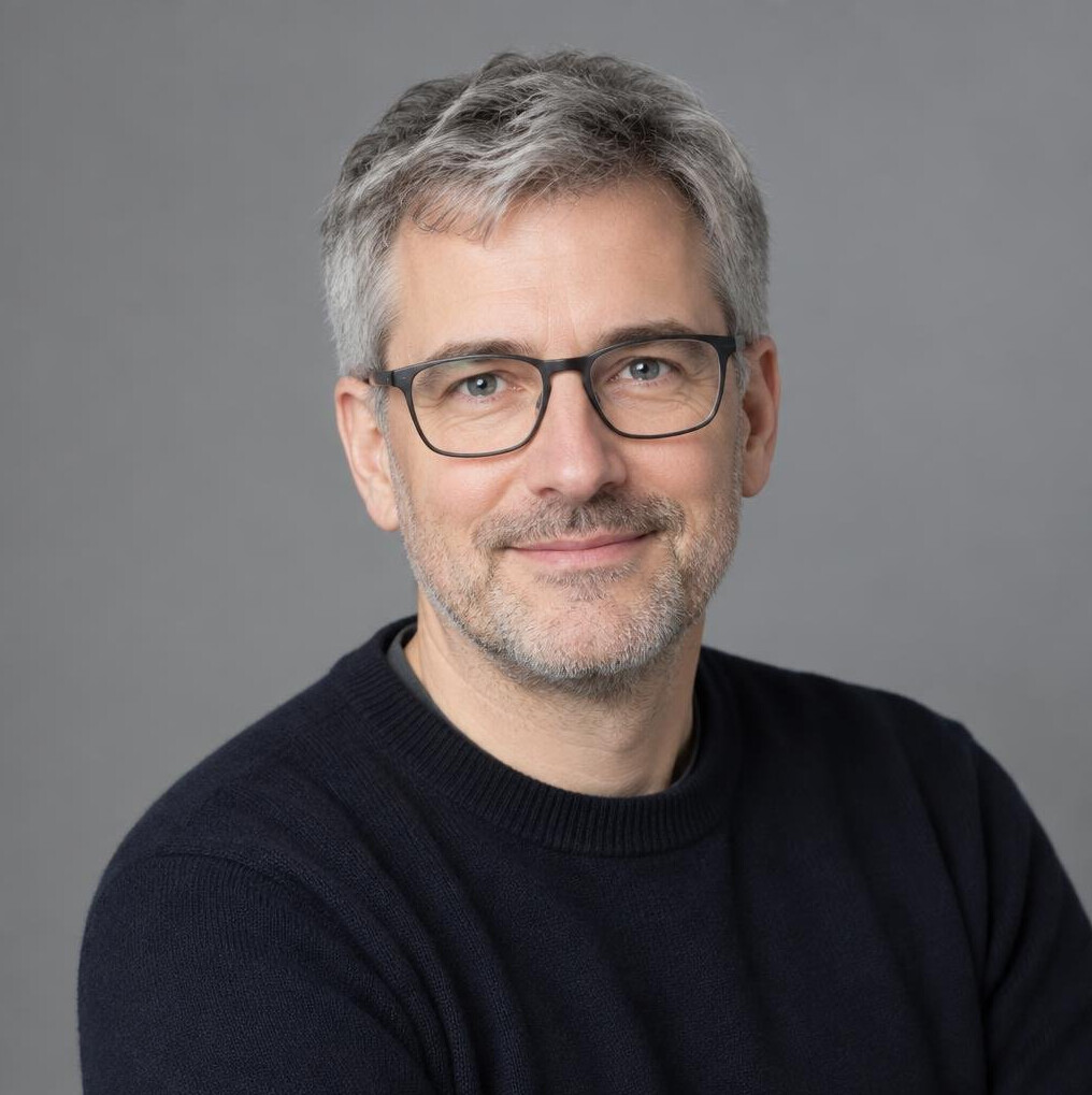 Studio portrait of a European man data journalist with glasses