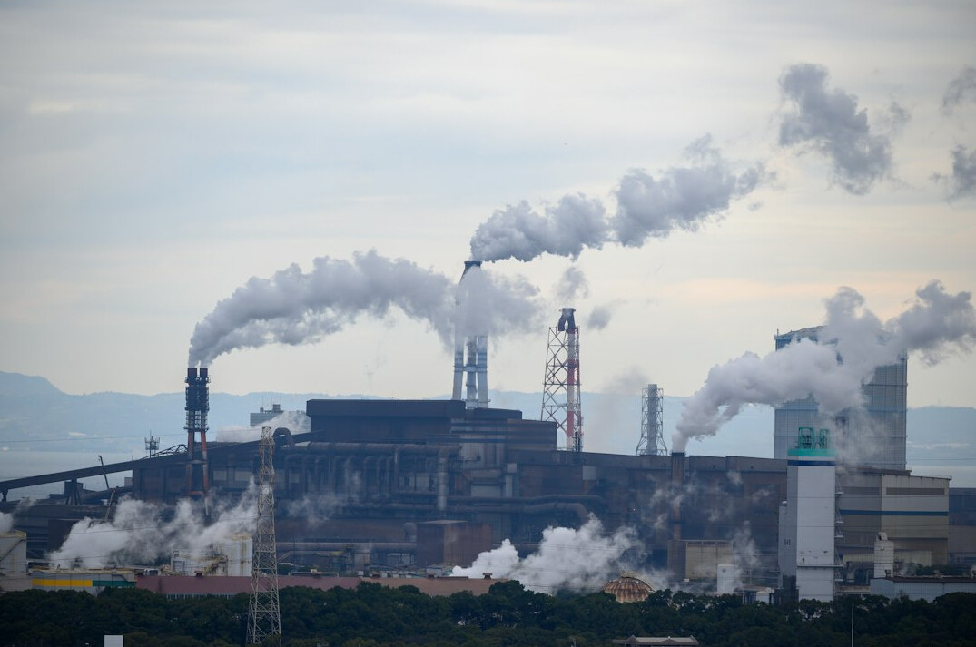 Industrial factory smokestacks emitting smoke