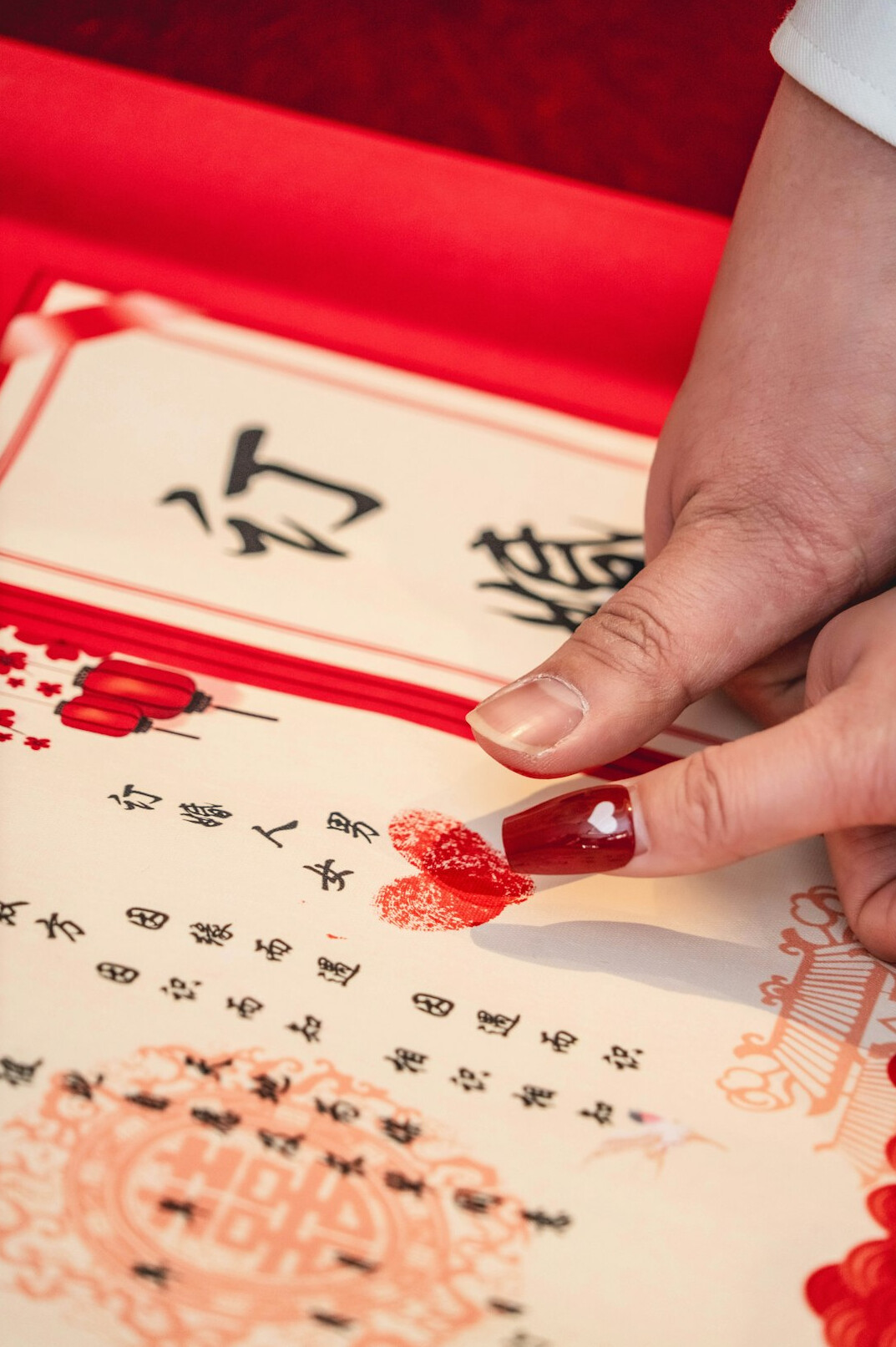 Close-up of hands annotating a printed document with a red pen