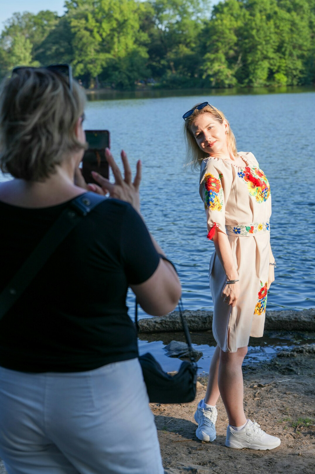 Journalist interviewing a resident near a lake shoreline